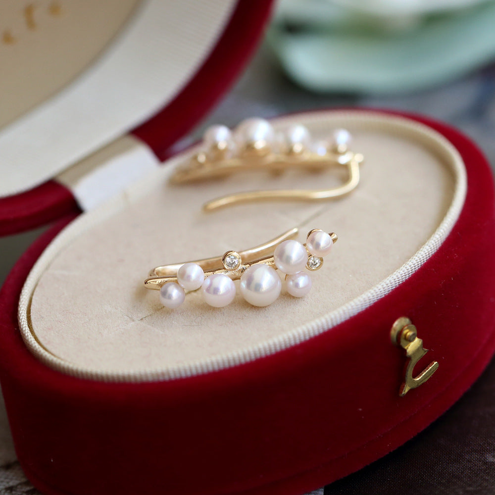 Gold and pearl hairpin in a red jewelry box