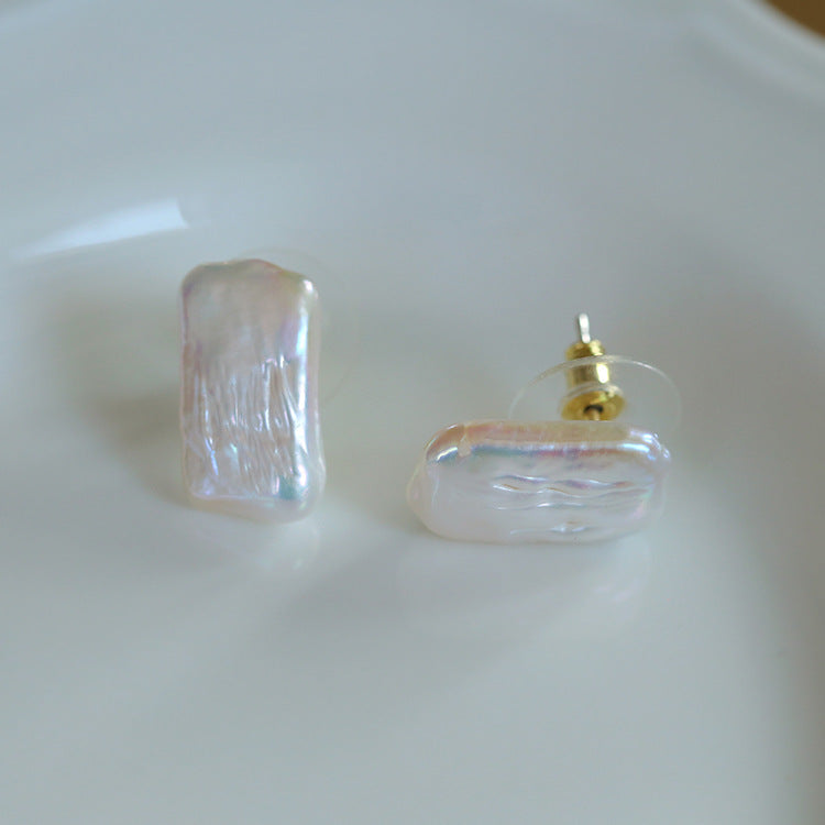 Pair of clear earrings with gold accents on a white background from Gembee Jewellery