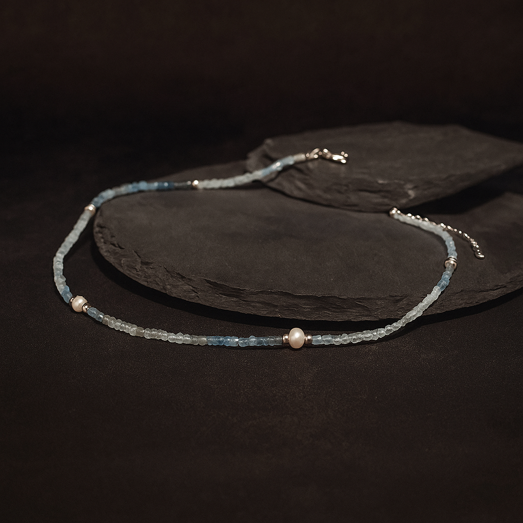 Delicate Aquamarine beaded necklace on a dark surface