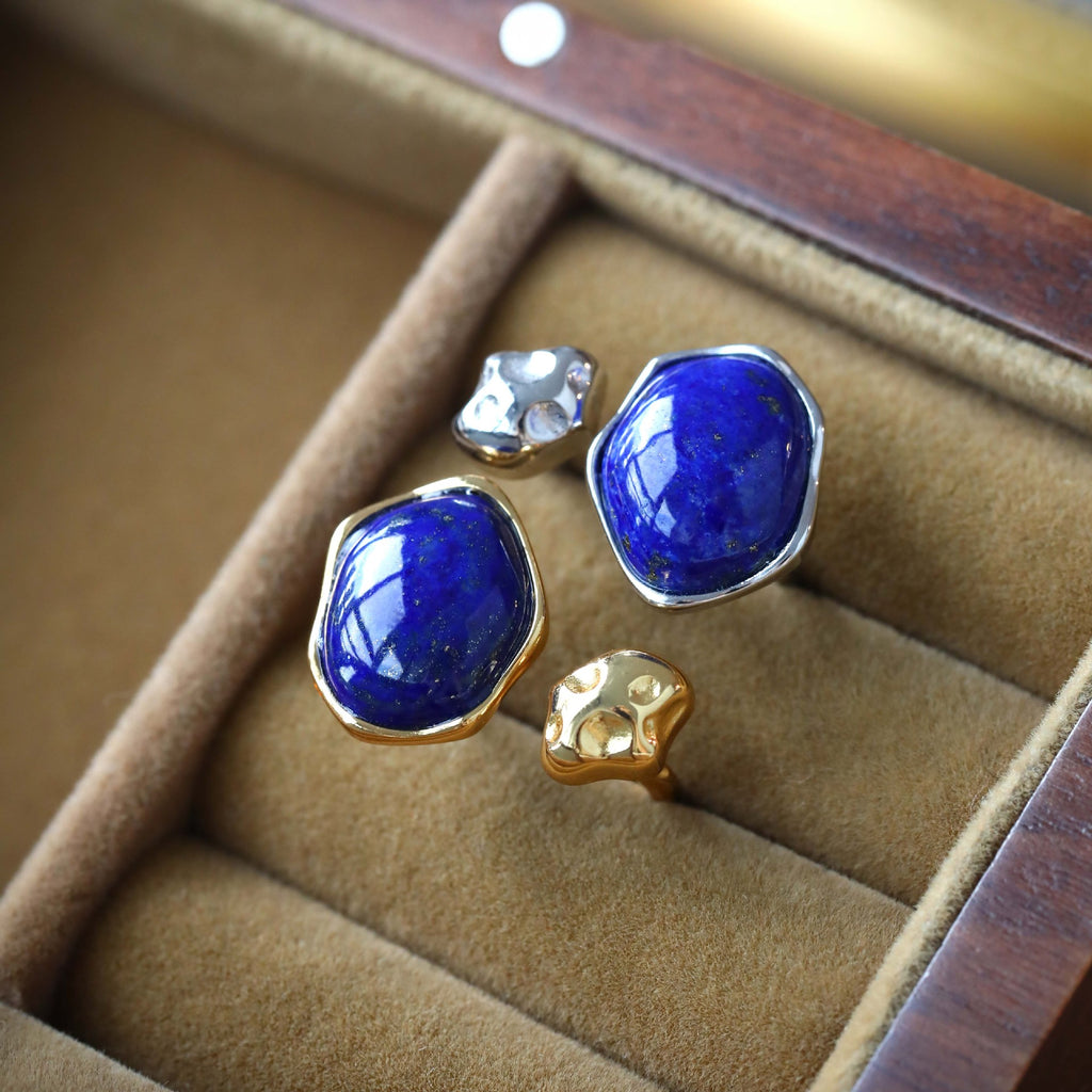 Pair of rings with Lapis Lazuli stone on a beige jewellery box.