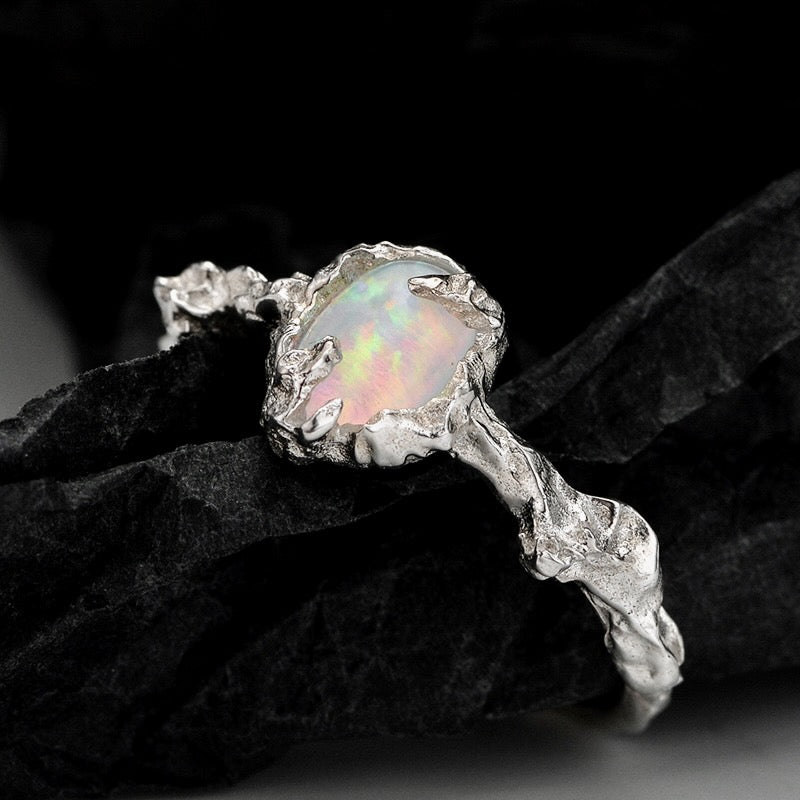 Silver ring with an opal stone on a dark background from Gembee Jewellery